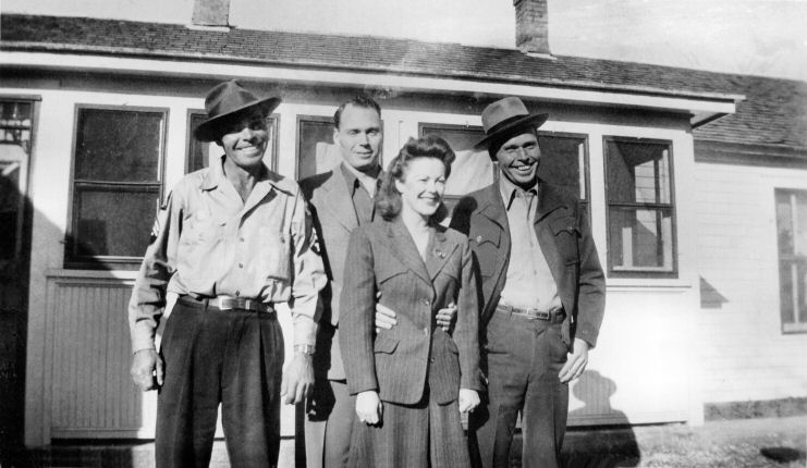Charlie Frain, Gene Frain, Micki (Hunter) Frain, Garold Frain.  Probably taken at the Frain farm, east of Culver, KS.